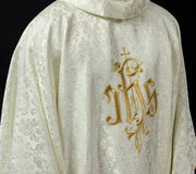 Ecru Chasuble with IHS embroidery on decorative fabric — front view
