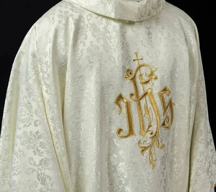 Ecru Chasuble with IHS embroidery on decorative fabric — front view