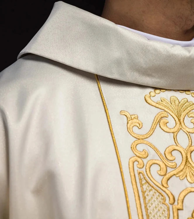 Ecru Chasuble with rich gold embroidery on a glossy band — close-up detail
