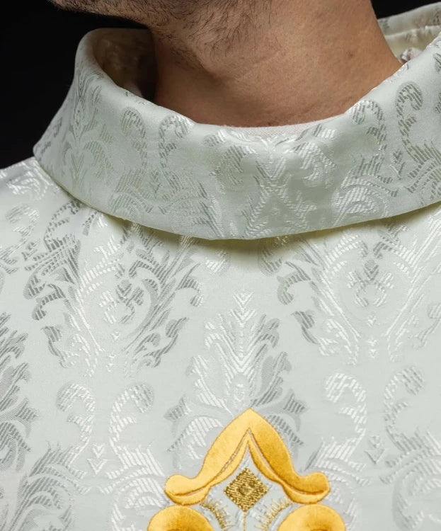 Ecru Chasuble with embroidered cross on patterned fabric — close-up detail