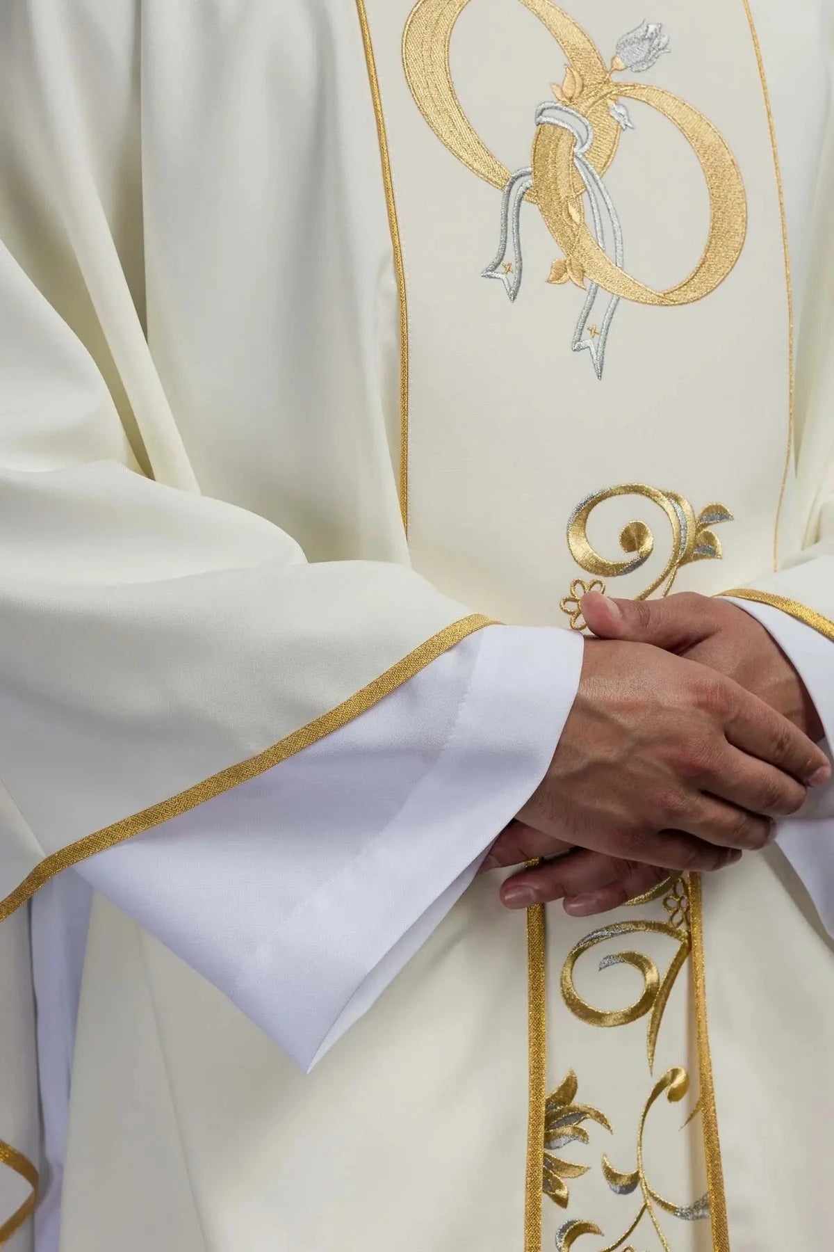 Embroidered wedding rings on an ecru chasuble – detail
