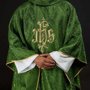 Green Chasuble with IHS embroidery on decorative fabric — front view