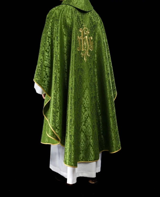 Green Chasuble with IHS embroidery on decorative fabric — fabric detail