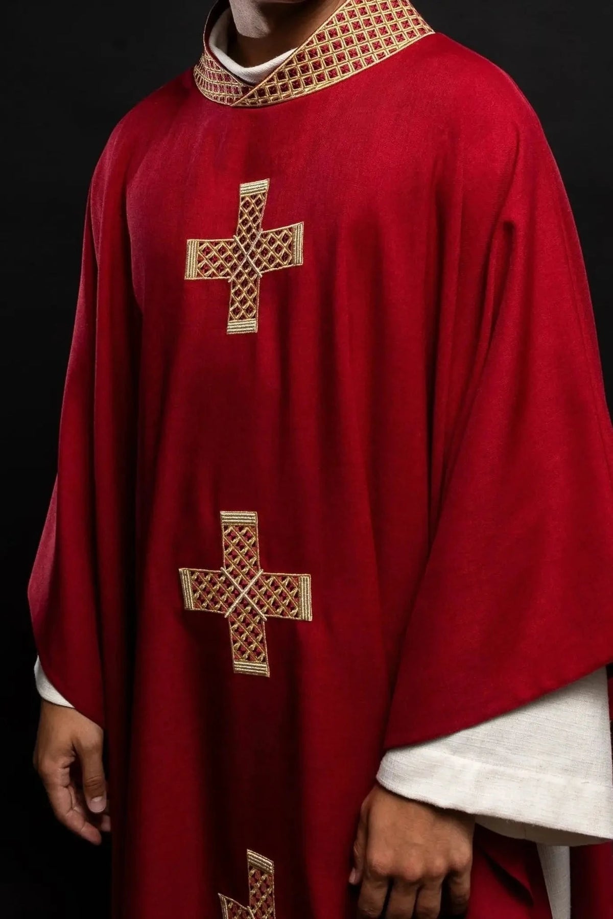 Red chasuble with gold cross embroidery — back view